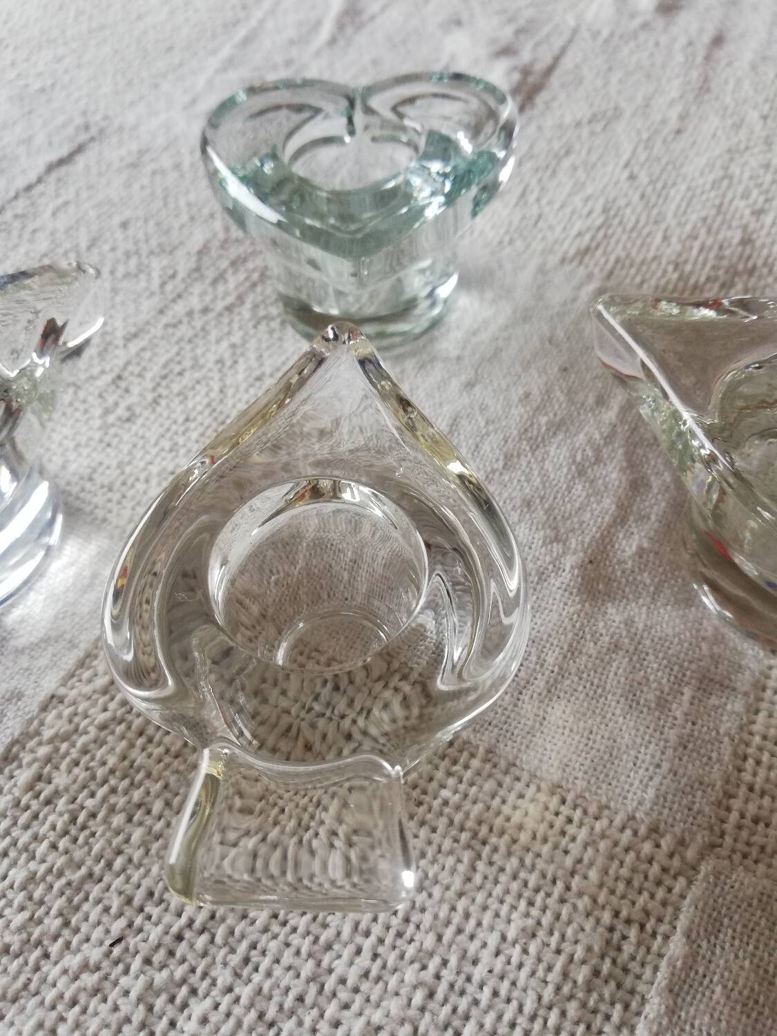 Set of four small transparent glass candle holders 3 spikes 1 heart