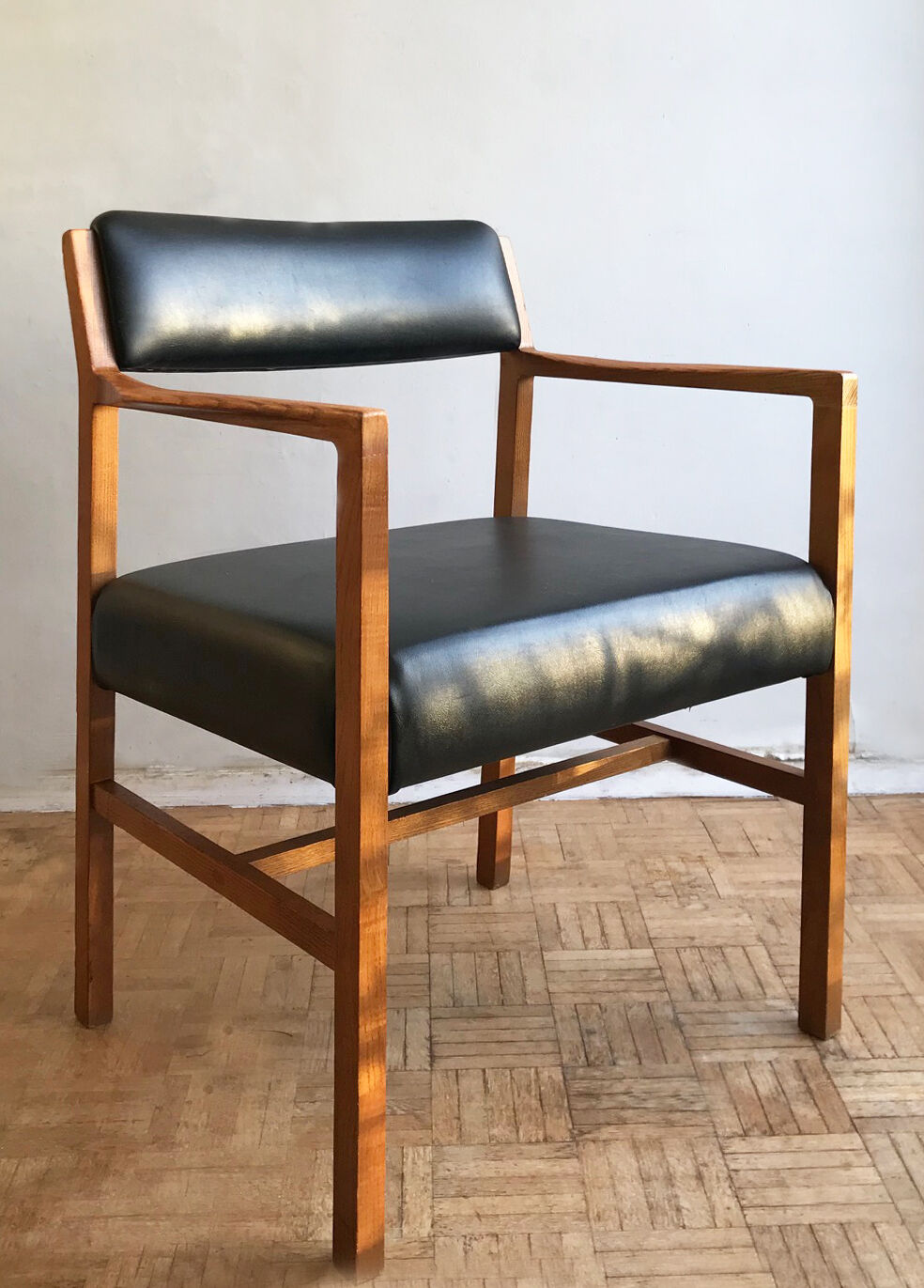 Chair in light teak and black skaï from the 1960s