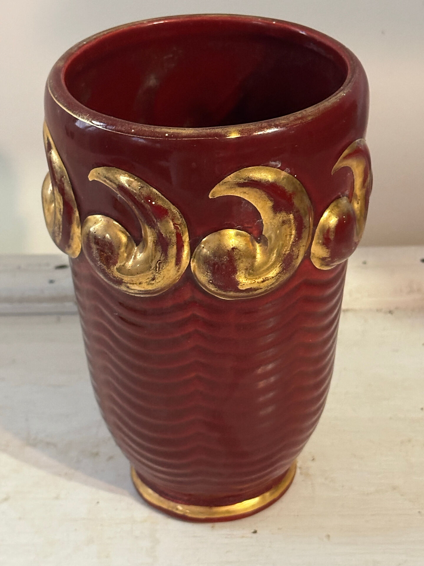 Mid-century relief vase in ruby red enhanced with gilding.