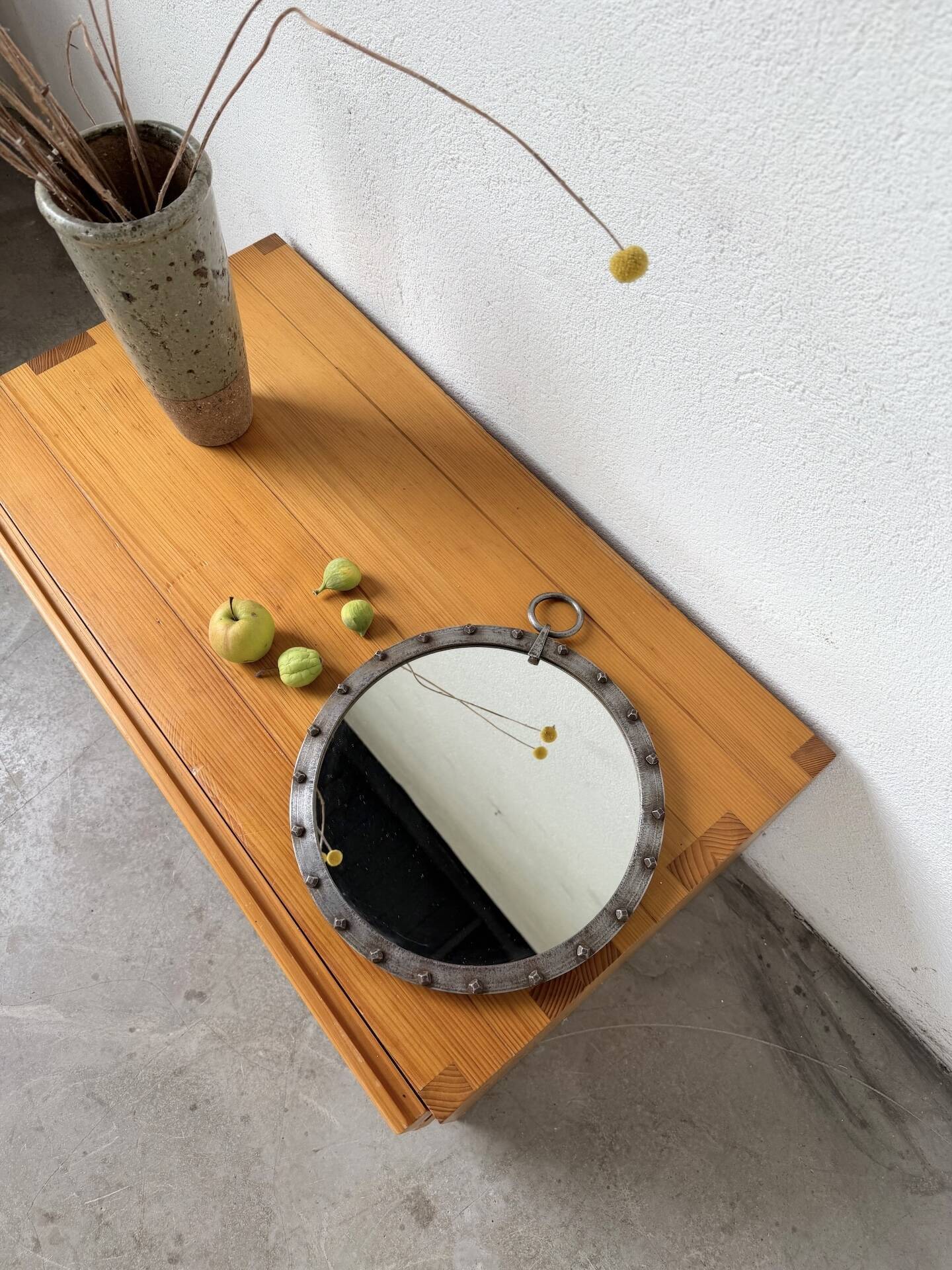 Brutalist round mirror with wrought iron and studs.