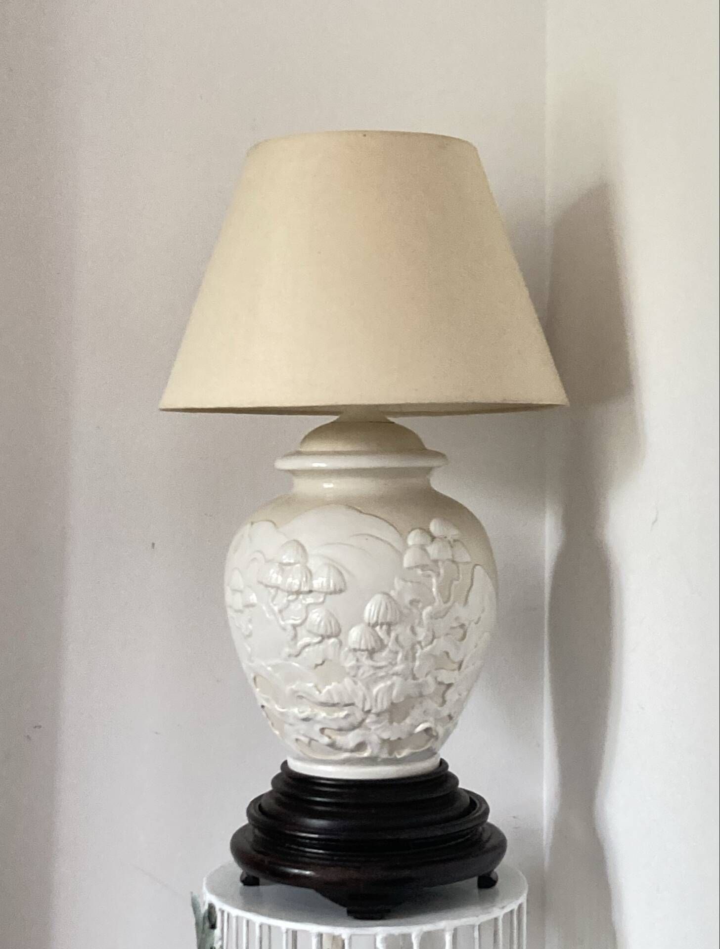 1980s ceramic table lamp with a wooden base and adjustable shade.