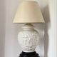 1980s ceramic table lamp with a wooden base and adjustable shade.