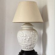 1980s ceramic table lamp with a wooden base and adjustable shade.