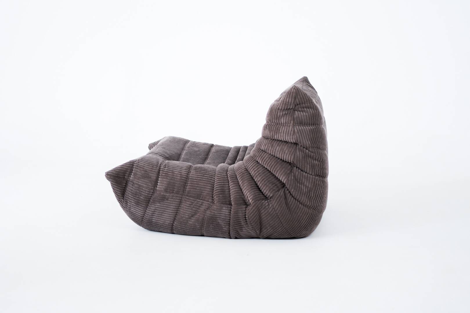 Ensemble de chaise et pouf Togo en velours côtelé marron.