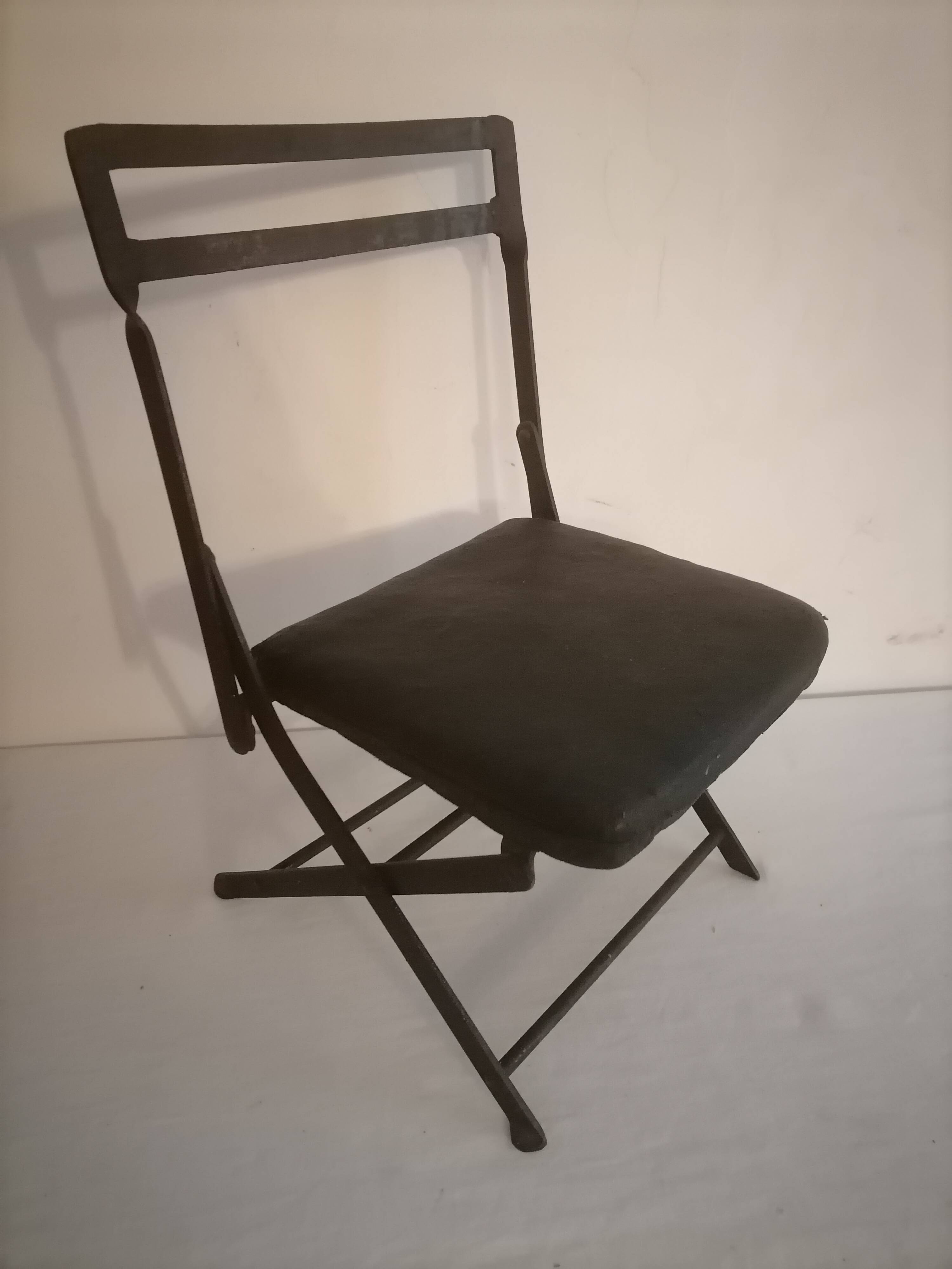Old wrought iron folding children's chair. Early 20th century.