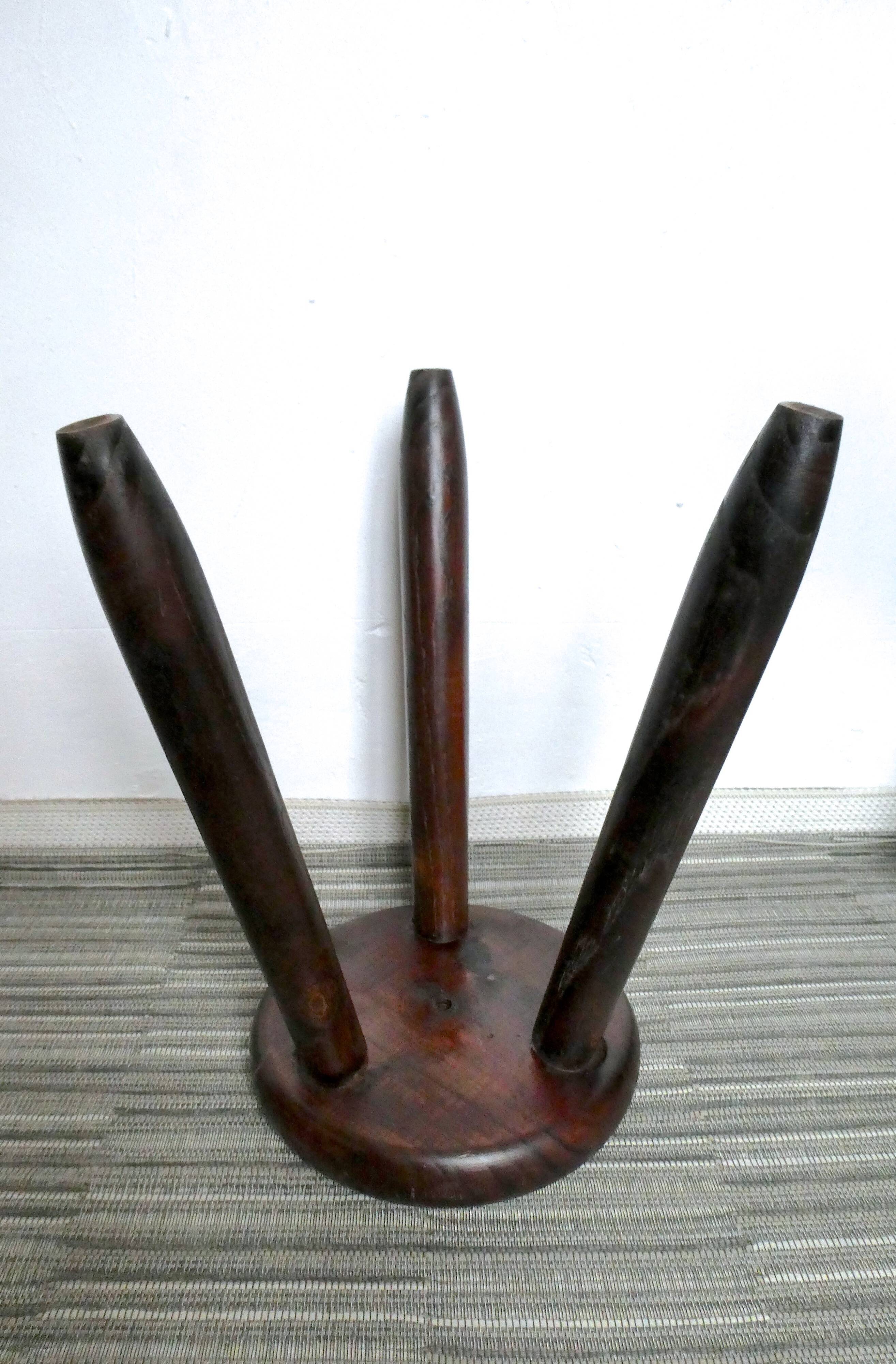 Dark wooden tripod stool