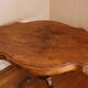 Large walnut guéridon with a sculpted base.