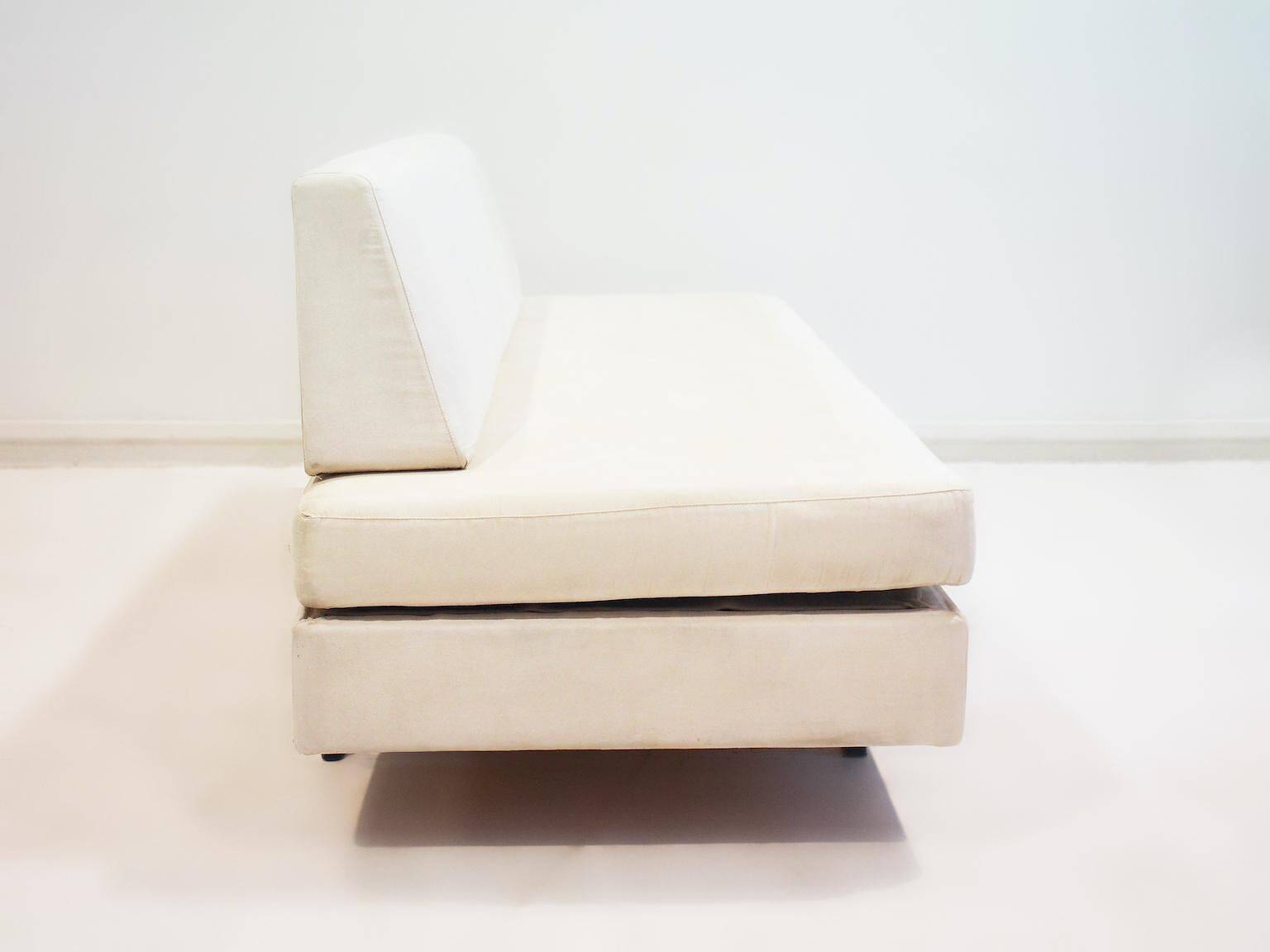Italian modernist daybed with white upholstery and iron frame.
