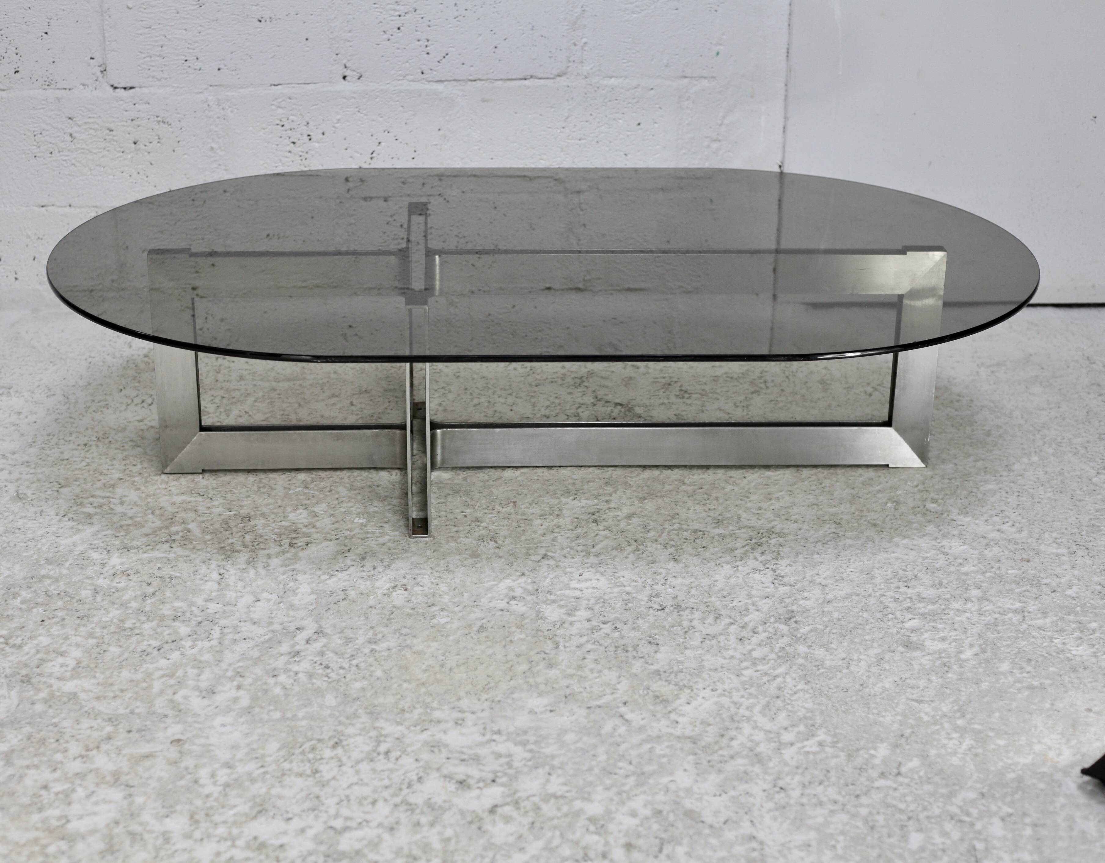 Coffee table with steel base and smoked glass slab. Circa 197