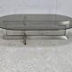 Coffee table with steel base and smoked glass slab. Circa 197