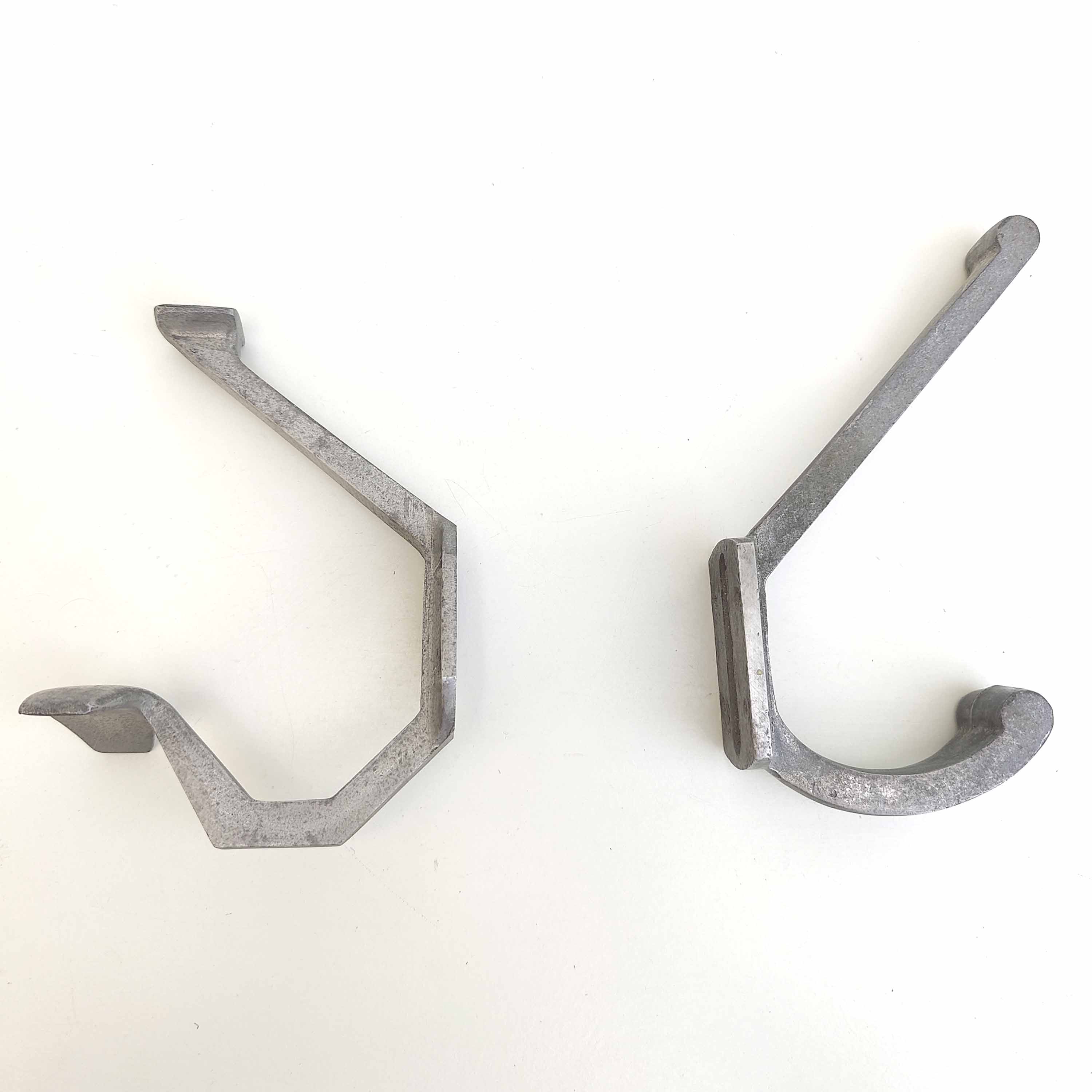 Two mismatched art deco aluminum hooks