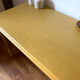 Desk table from the late 19th century, painted mustard, with turned stretcher.
