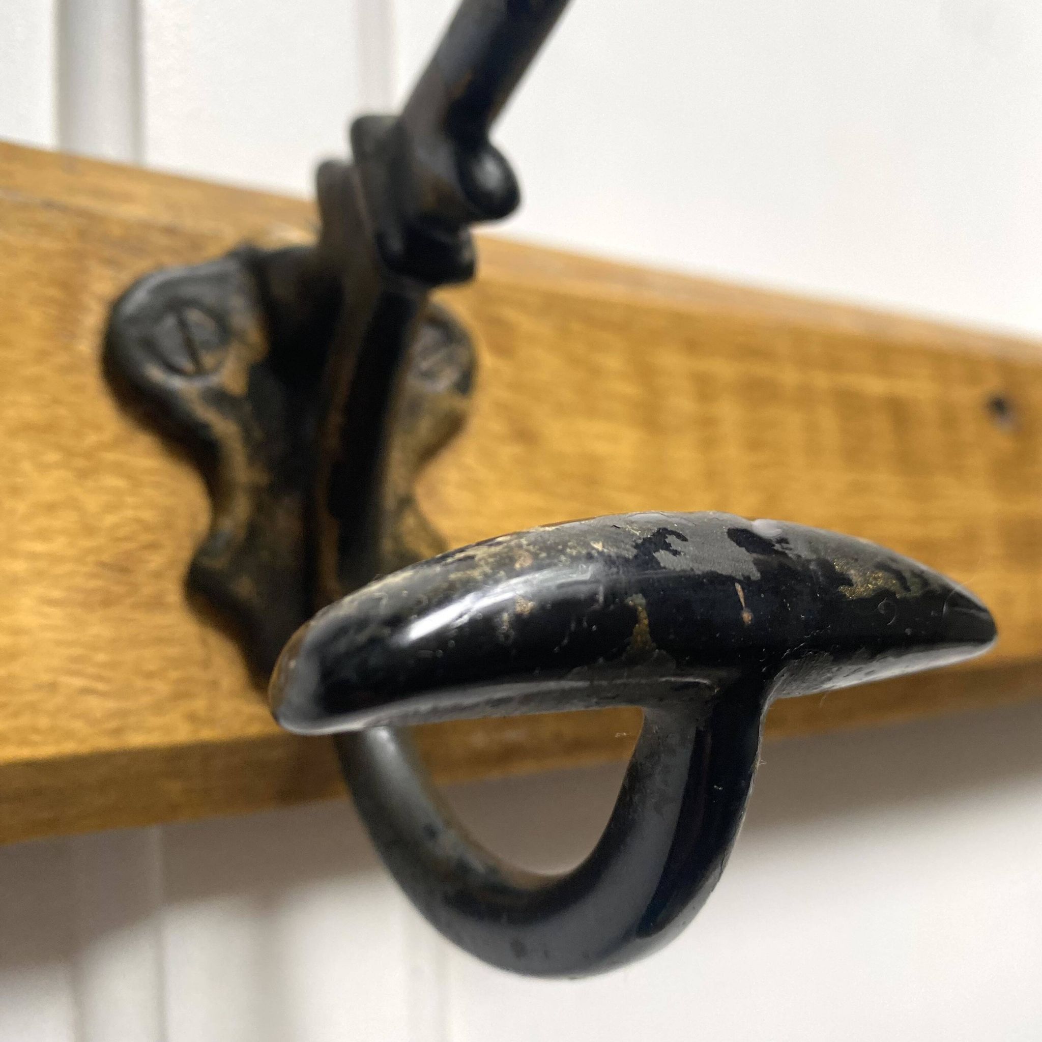 Antique wooden coat rack with metal hooks