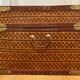 Beautiful vintage Chinese trunk in wicker, black and gold lacquered wood, and brass.