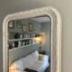 Antique Louis-Philippe mirror with pearls and shells, white patina.