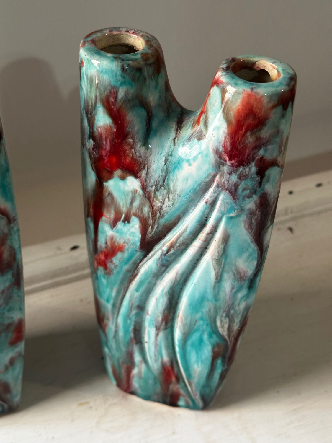 Vintage pair of turquoise and red ceramic candlesticks