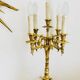 Massive gilded bronze chandeliers from the mid-20th century with marble bases.