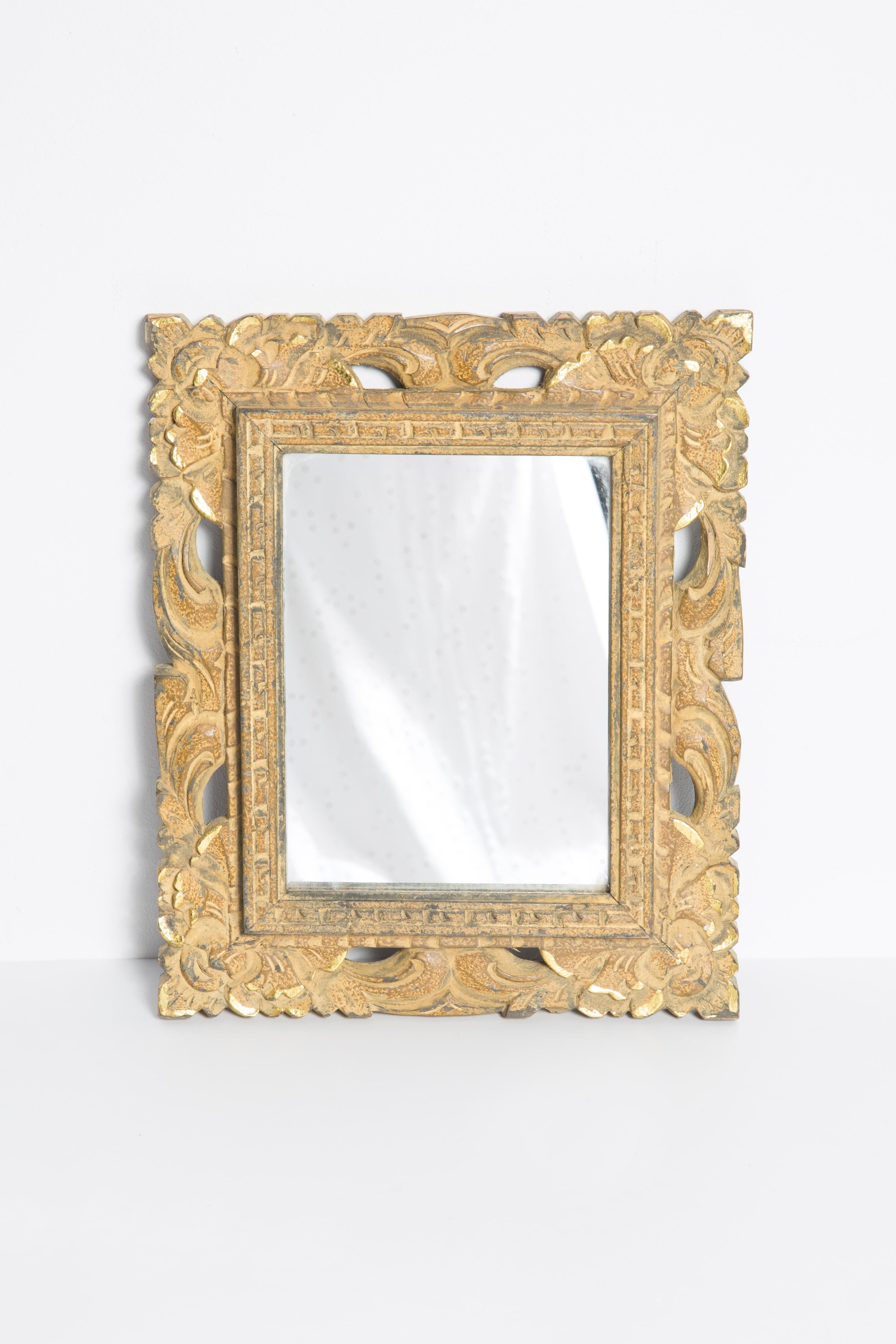 Decorative gold mirror mid-century in a wooden frame, Italy, 1960s.
