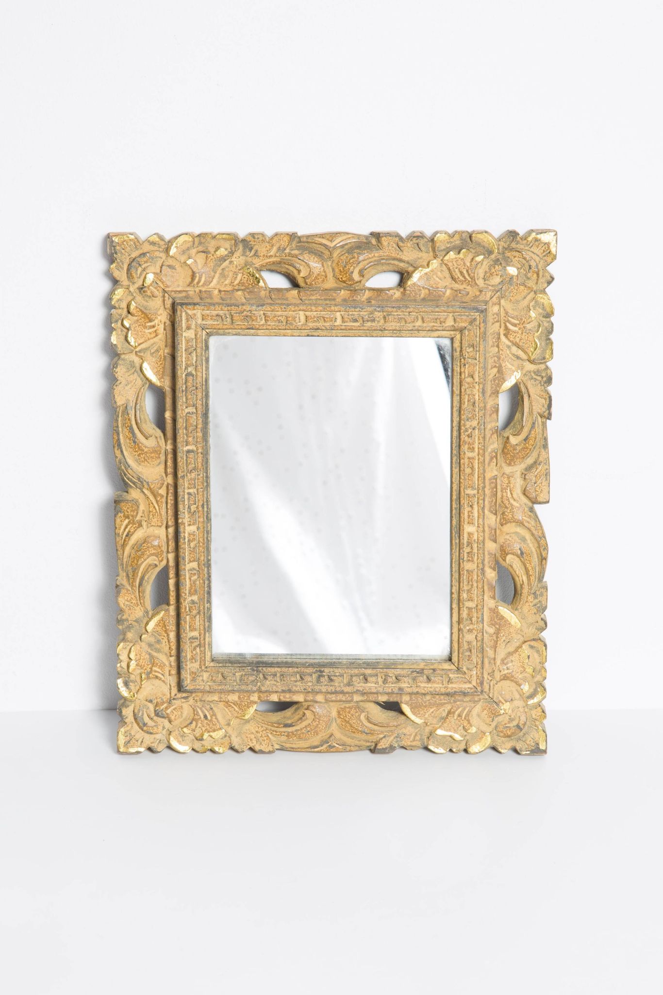 Decorative gold mirror mid-century in a wooden frame, Italy, 1960s.