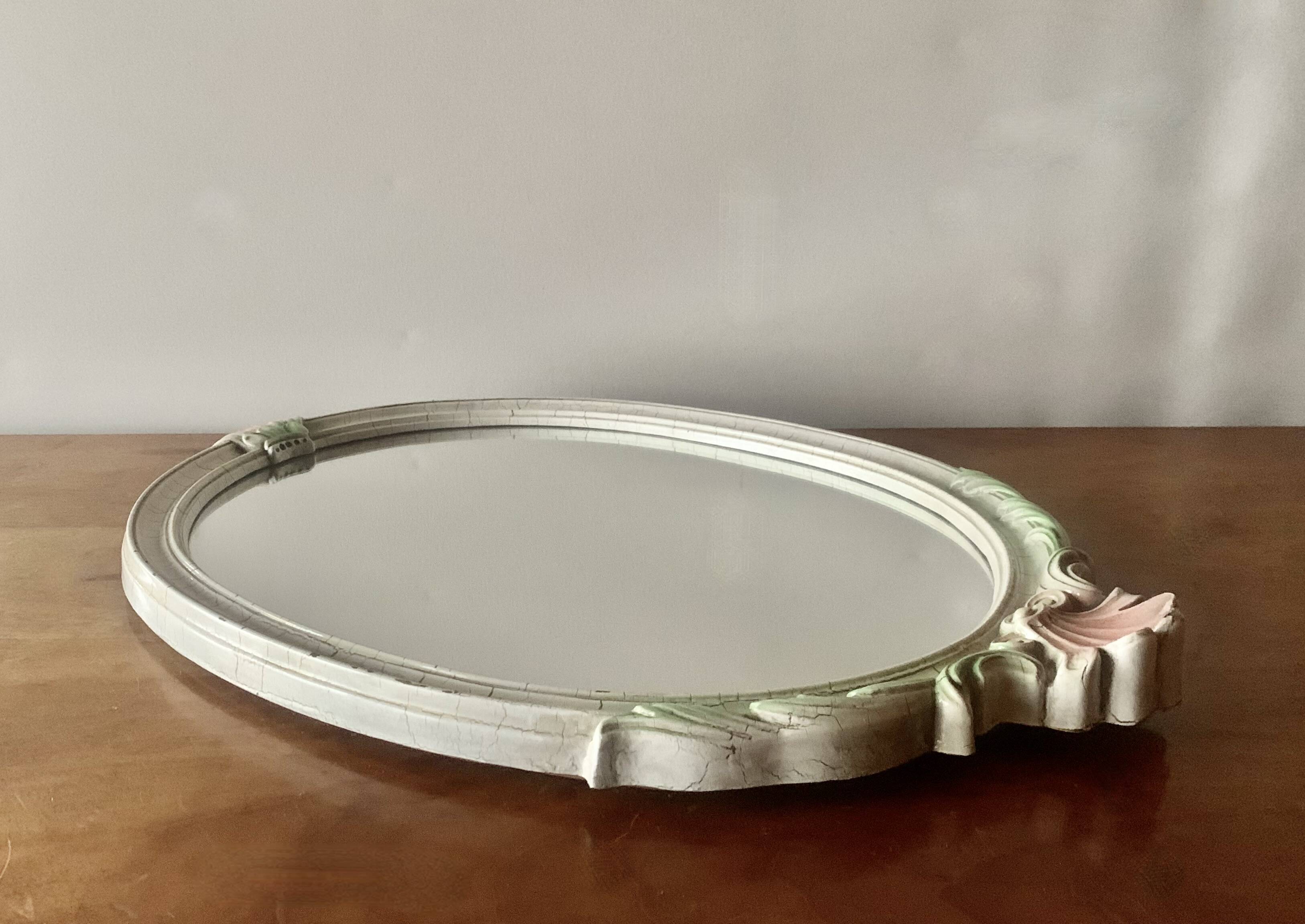 Vintage oval mirror in carved wood in pastel tones