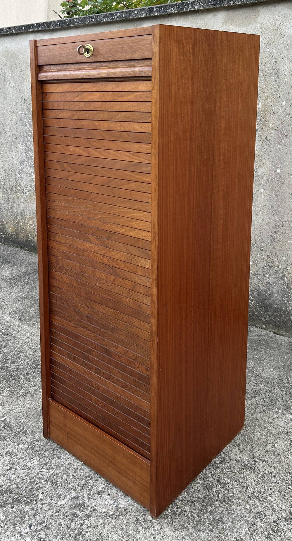 Vintage wooden filing cabinet with curtains.