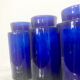 Suite of four bottles of ancient apothecary in blue breath glass