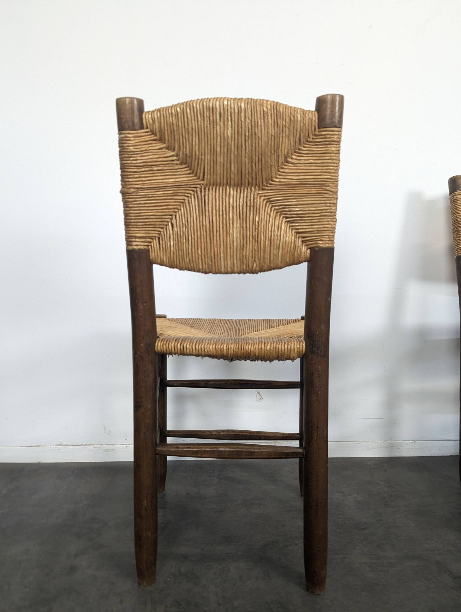 Set of 10 Bauche model chairs by Charlotte Perriand, circa 1960.