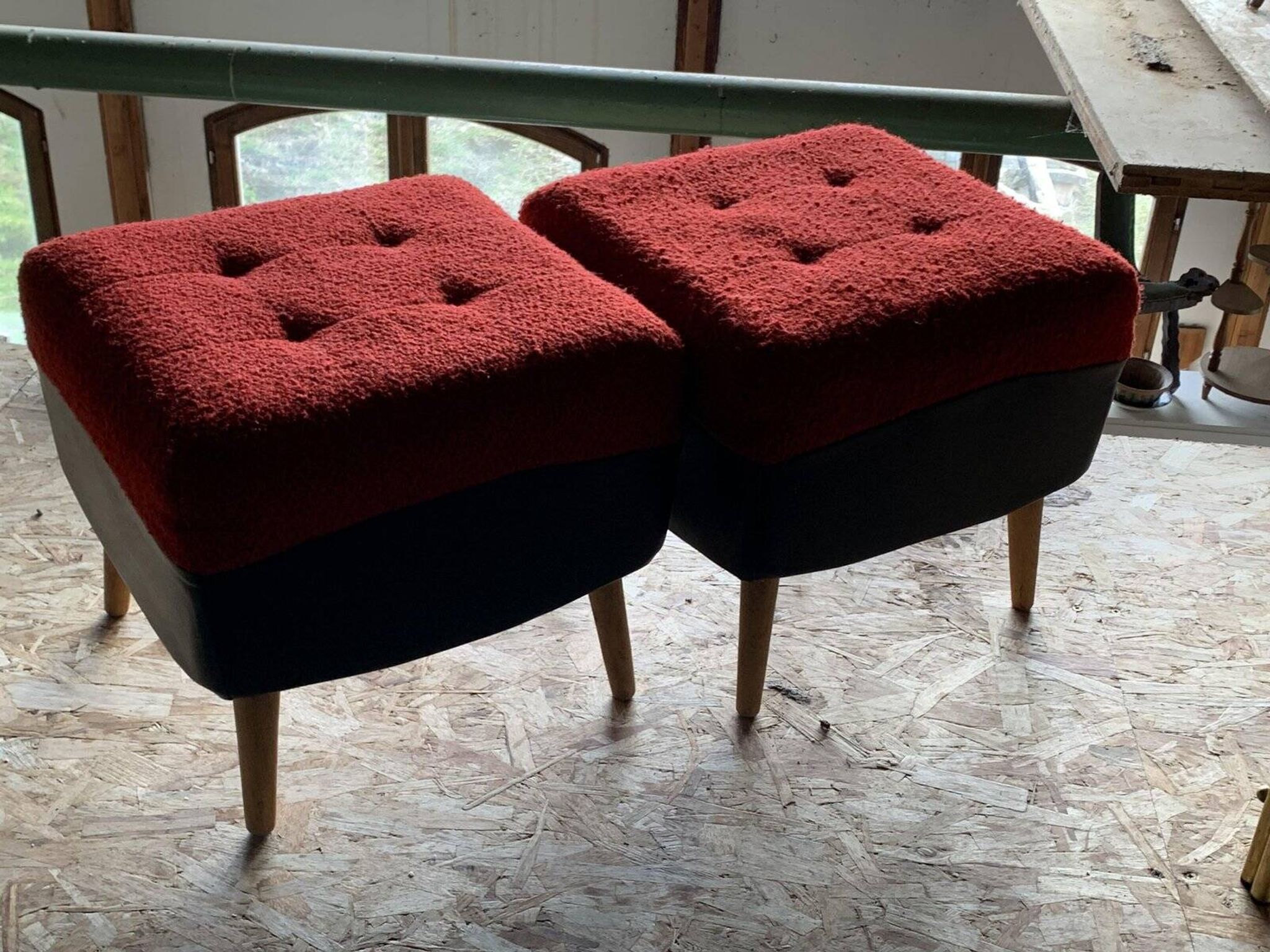 Set of 2 mid-century stools in red and black fabric and faux leather, with light wood legs.