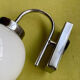 Pair of chrome metal wall lights with white glass globe.