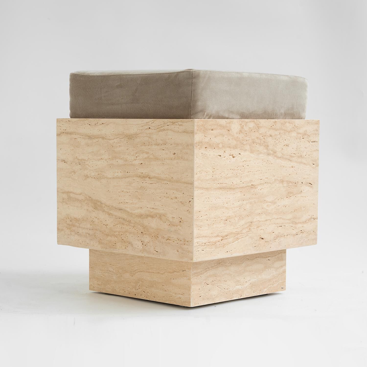 Cubic travertine stool with velvet cushion
