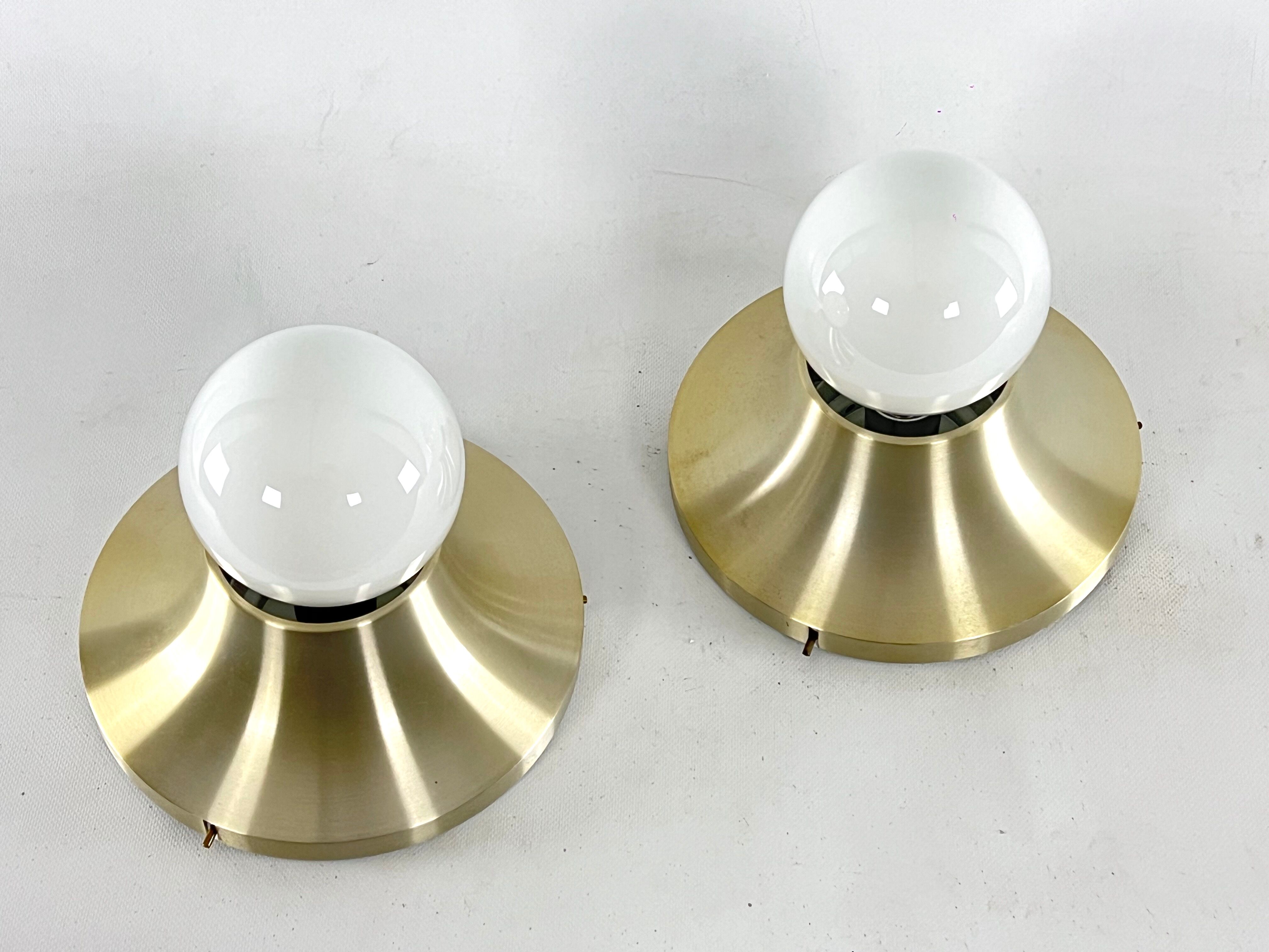 Stilux Milano, vintage round gilded aluminum wall lamps from 60s. Set of two