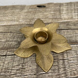 Old golden brass candle holder in the shape of a leaf or flower