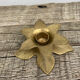 Old golden brass candle holder in the shape of a leaf or flower