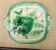 Old square plate in slipware with plant decoration.