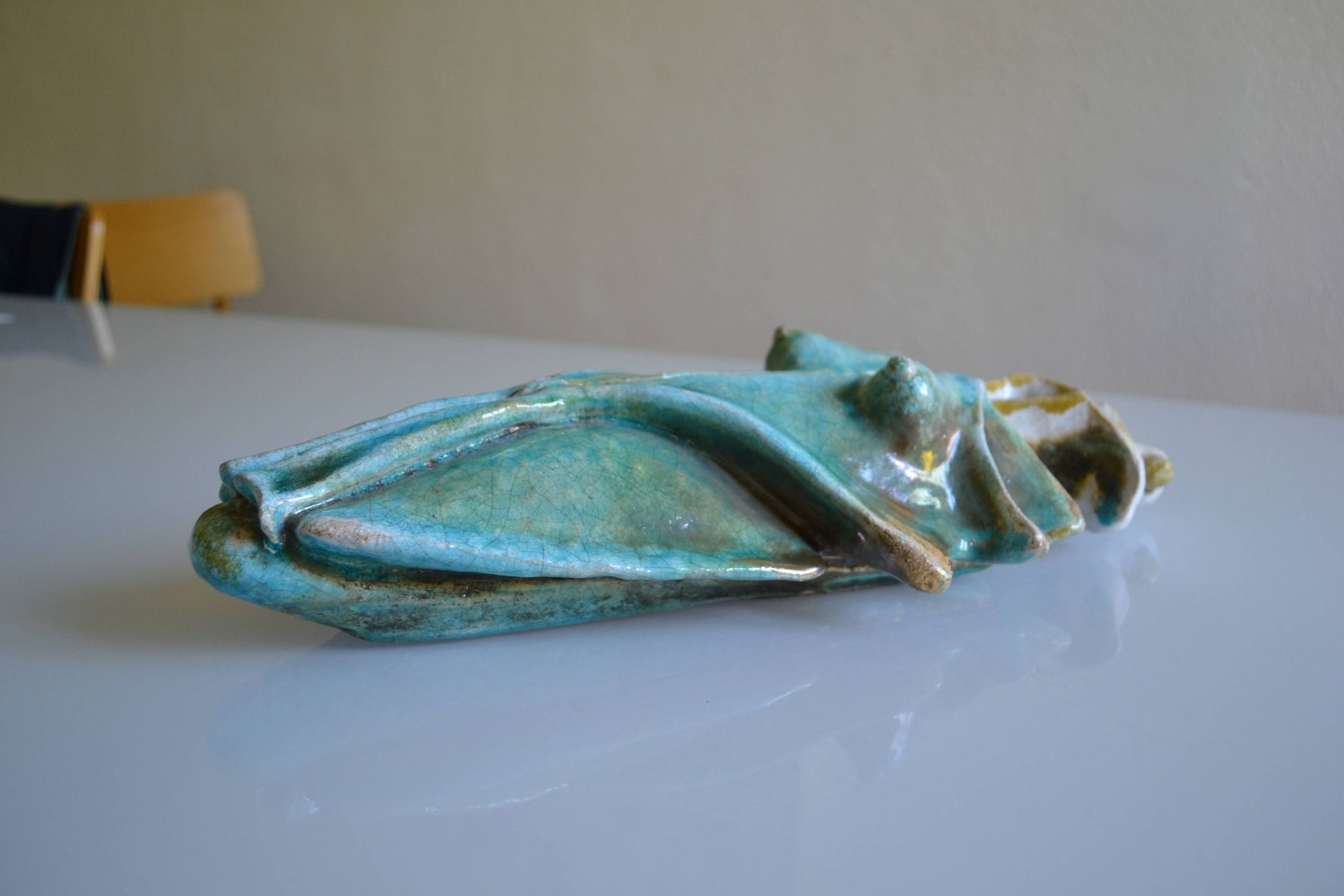 Surreal ceramic sculpture in relief signed to be identified.