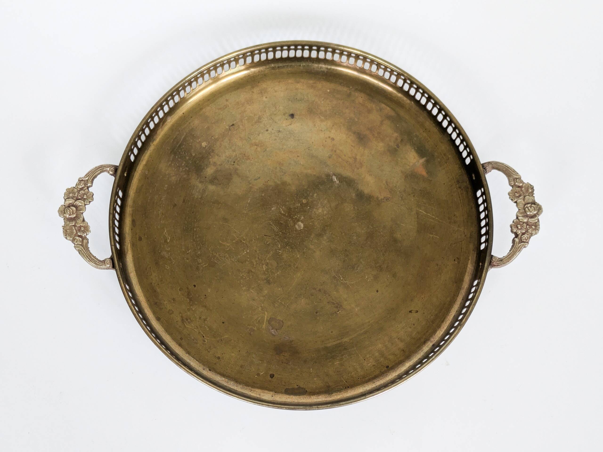 Vintage decorative brass tray, pierced edge and floral handles.