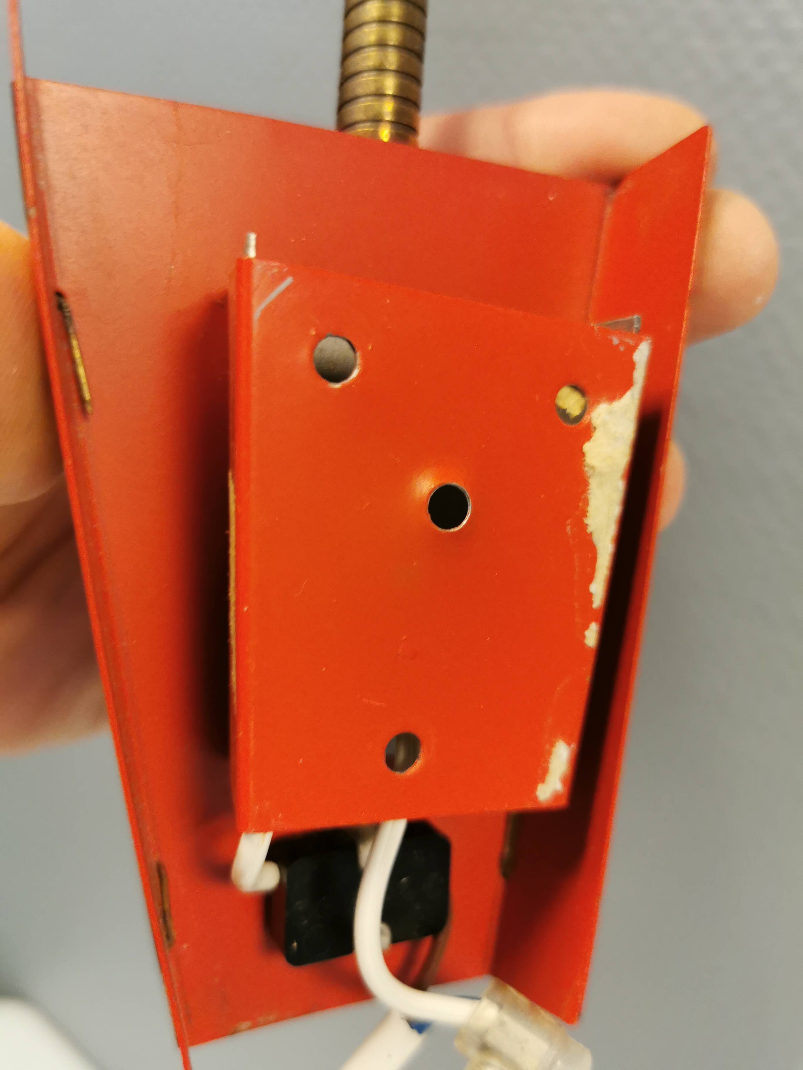 Danish red lacquered wall light with brass details. Estimated 1980s