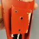 Danish red lacquered wall light with brass details. Estimated 1980s