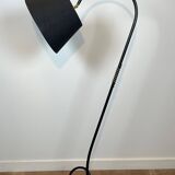 Design floor lamp in black lacquered metal and brass.