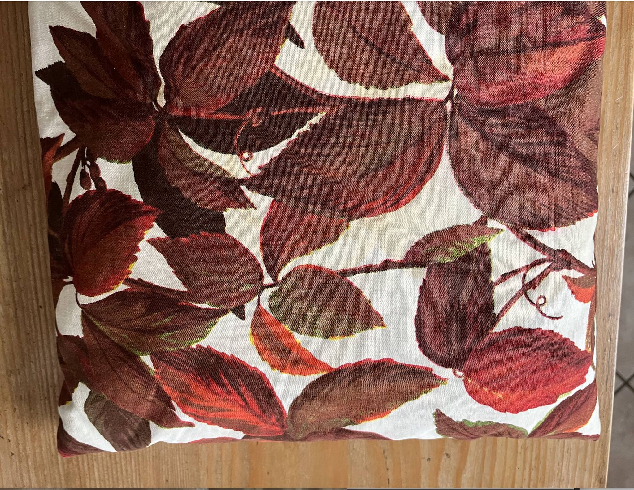 Vintage cushion with virgin vine leaf pattern.