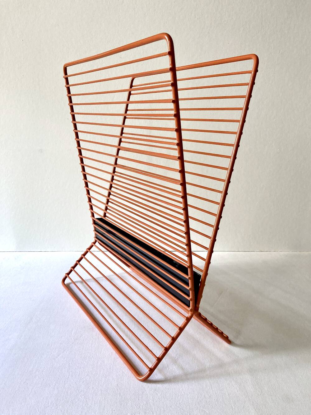 Wire metal magazine rack with triangular compartment, 1950s.