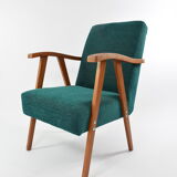 Green curved armchair