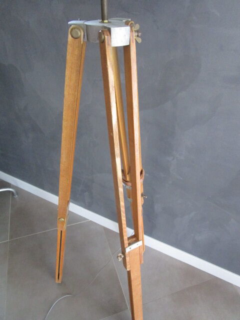 Old floor lamp on surveyor tripod