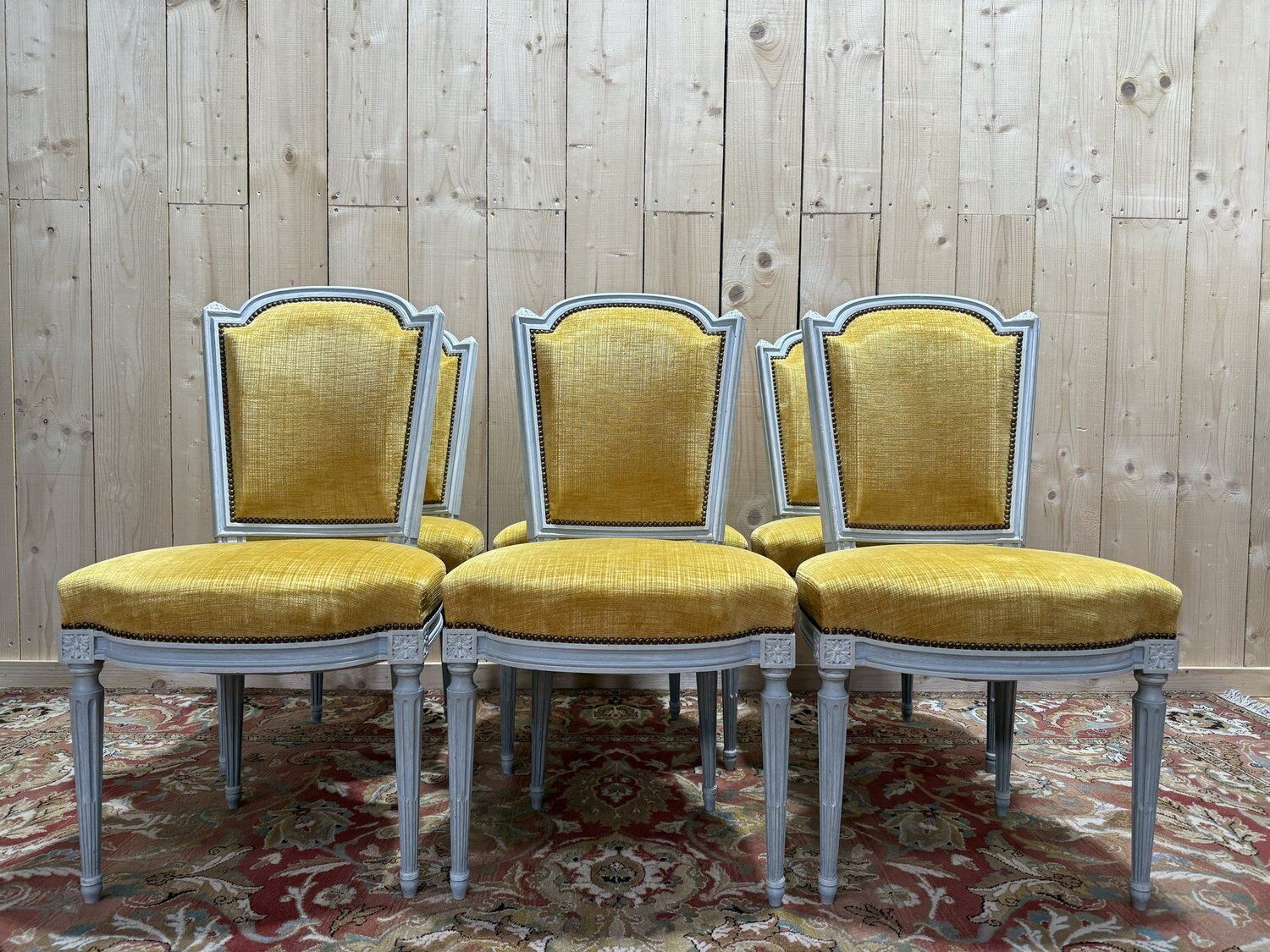 Set of 6 Louis XVI style chairs with polished wood and velvet.