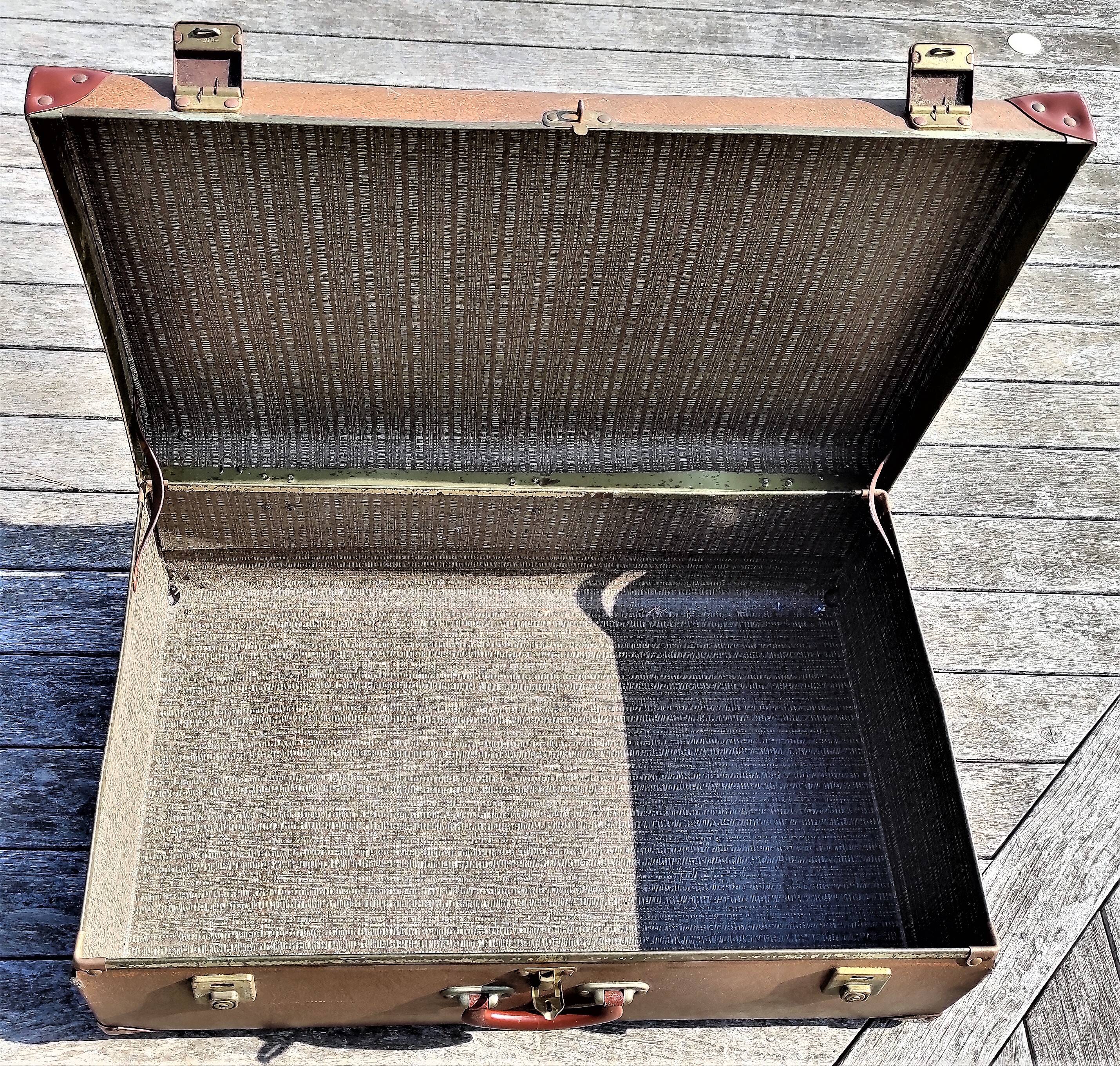 Brown vintage suitcase with CHENEY England brand travel tags