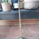 Ashtray on foot. Bronze and brass, with fleur-de-lis decoration.