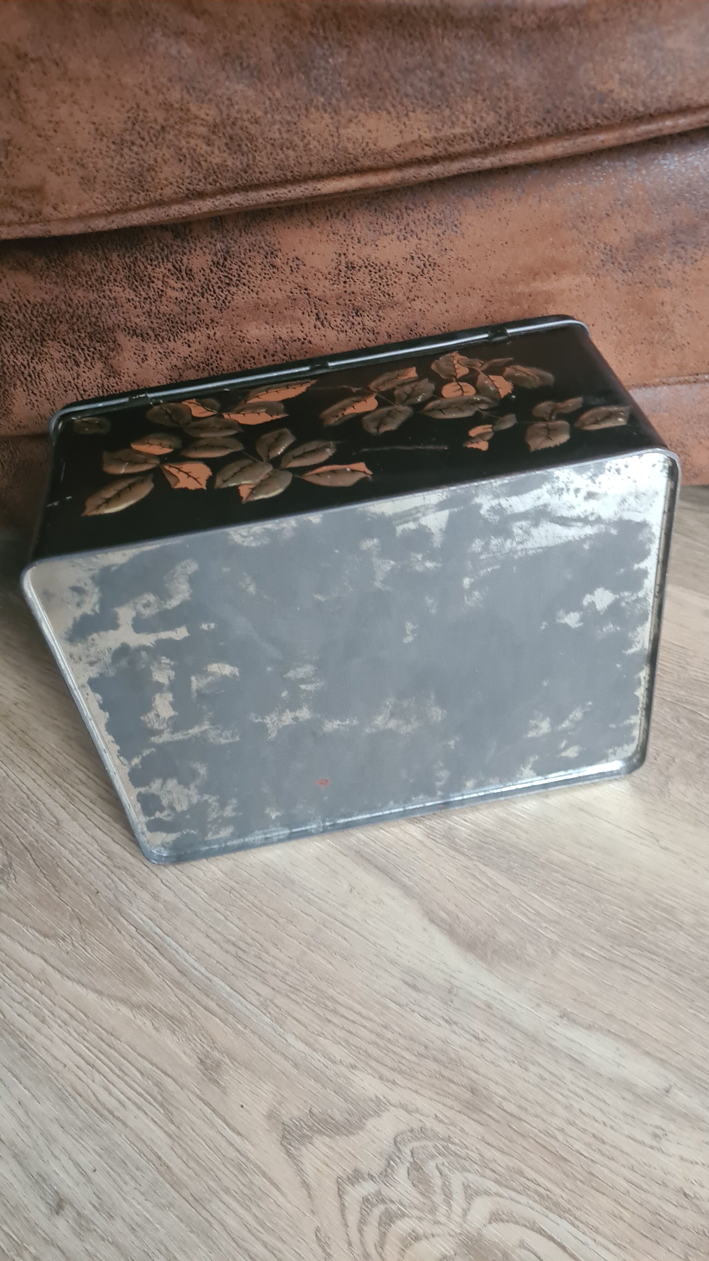 Old black metal box and flowers at the beginning of the century