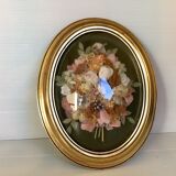 Golden oval frame dried flowers