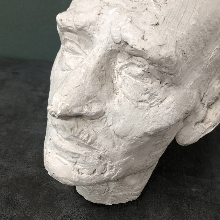 Head of a man with a plaster mustache