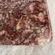 Pink marble trivet with brass ball feet.